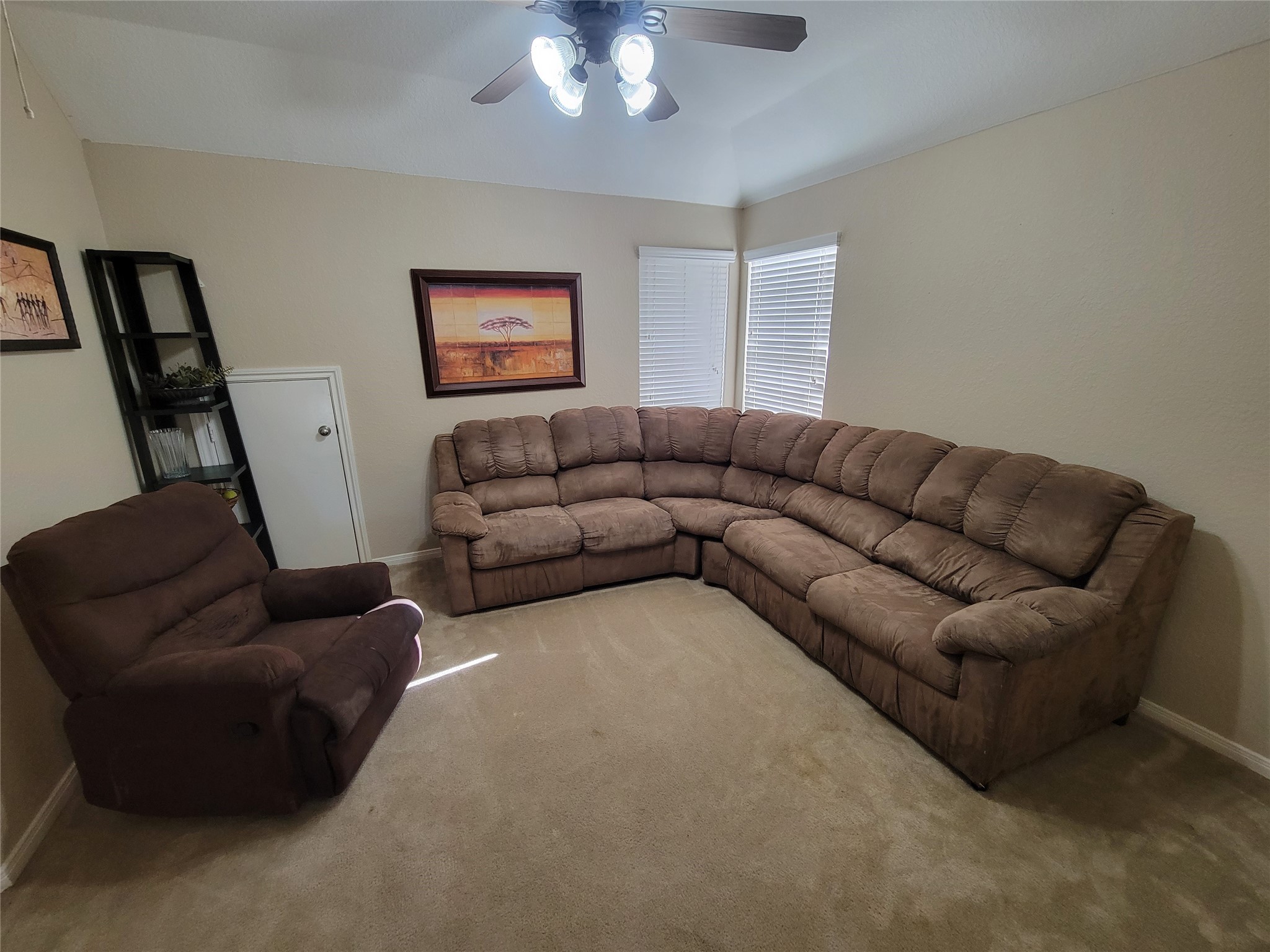 130 Zephyr Bend Place The Woodlands, TX 77381 - Photo 19 of 29 a living room with furniture a couch and a chandelier