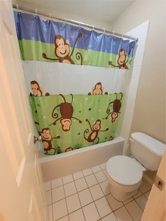 a bathroom with a toilet and a bathtub