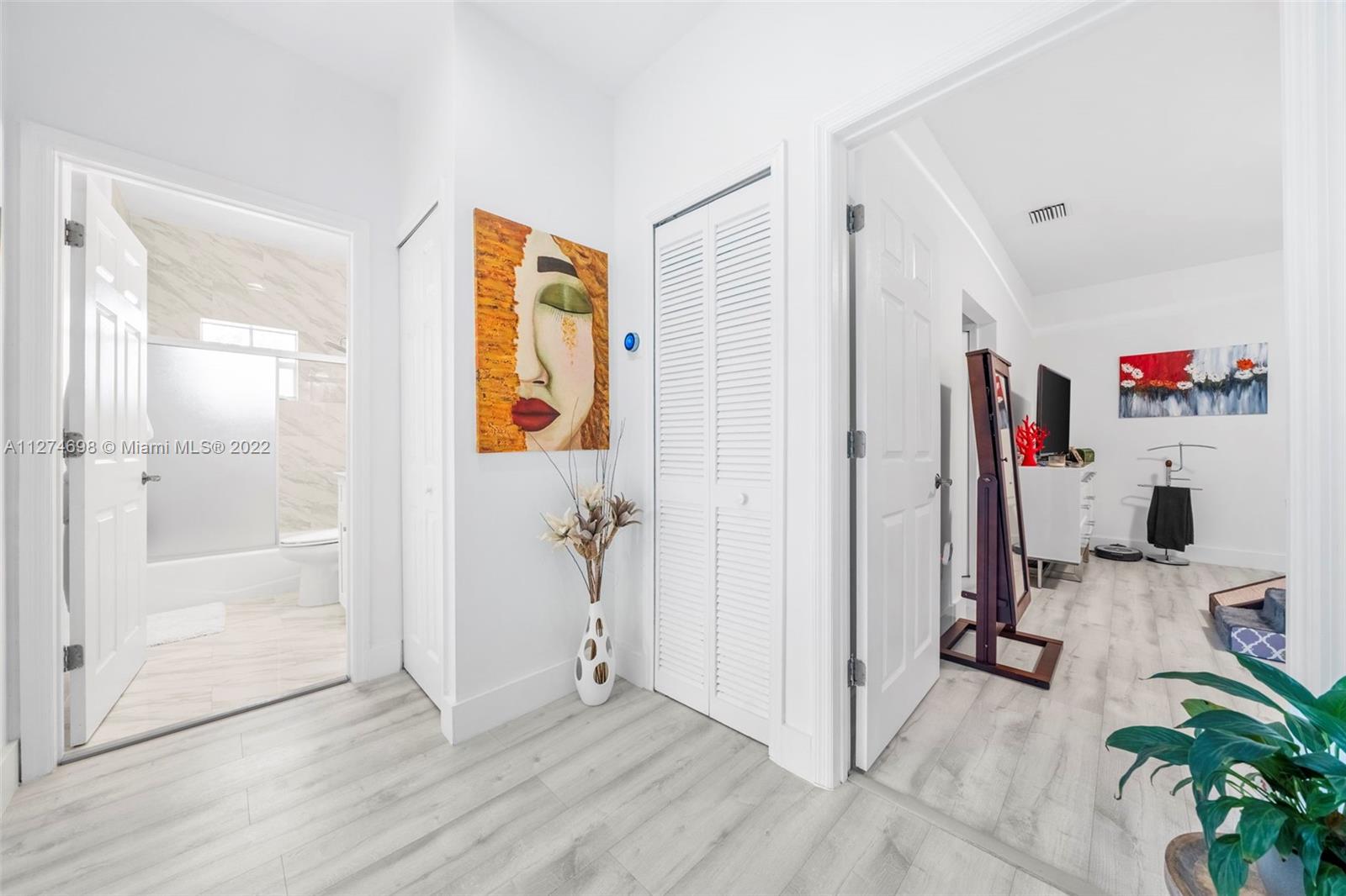 442 Fernwood Road Key Biscayne, FL 33149 - Photo 12 of 33 a view of a hallway with bathroom and glass door