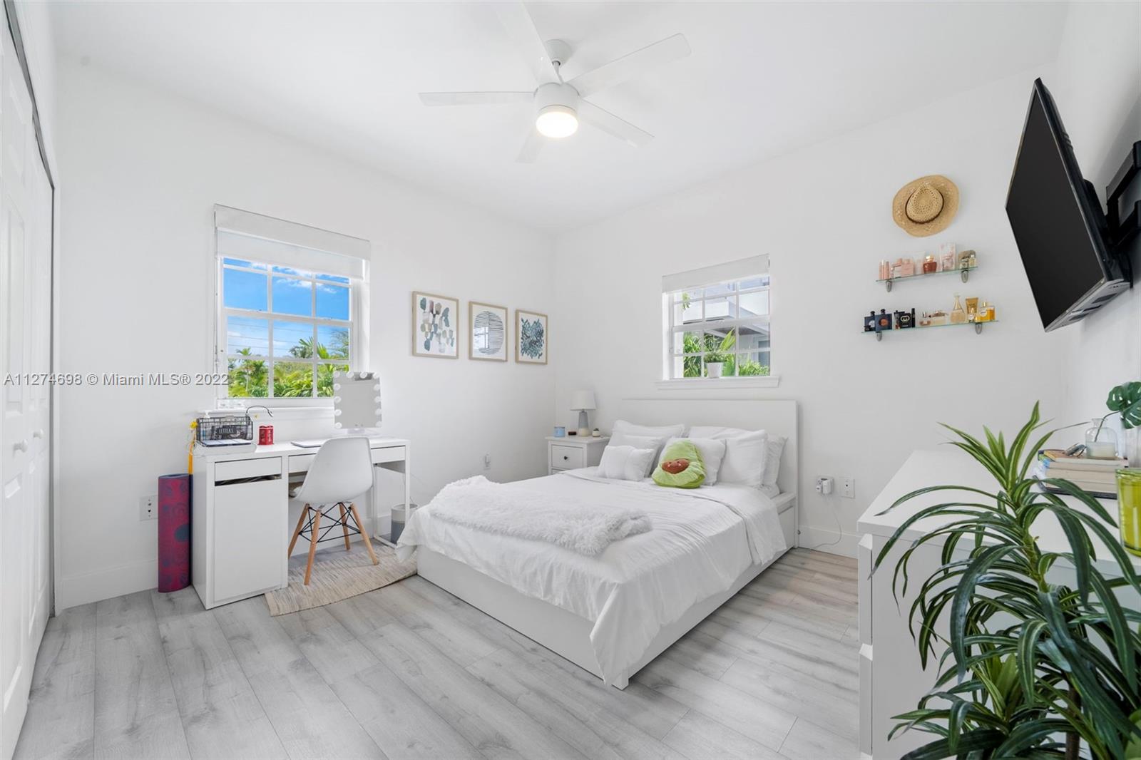 442 Fernwood Road Key Biscayne, FL 33149 - Photo 17 of 33 a bedroom with a bed and flat screen tv