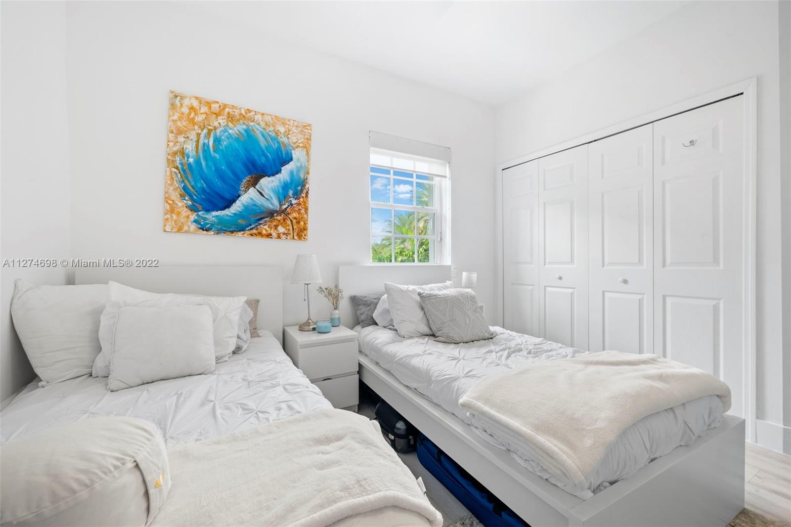 442 Fernwood Road Key Biscayne, FL 33149 - Photo 18 of 33 a bedroom with a bed and cupboard