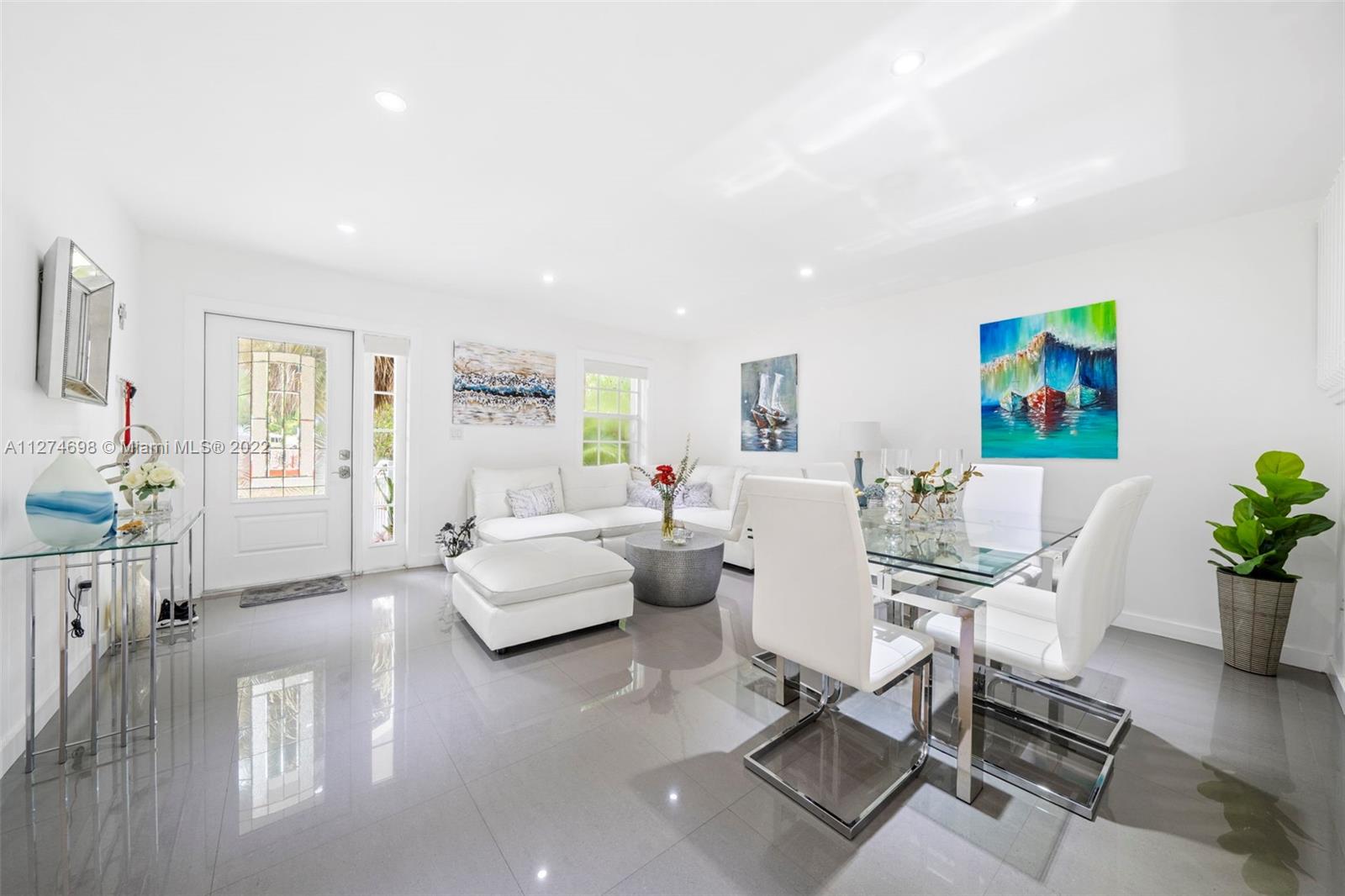442 Fernwood Road Key Biscayne, FL 33149 - Photo 2 of 33 a living room with furniture or wooden floor and a large window