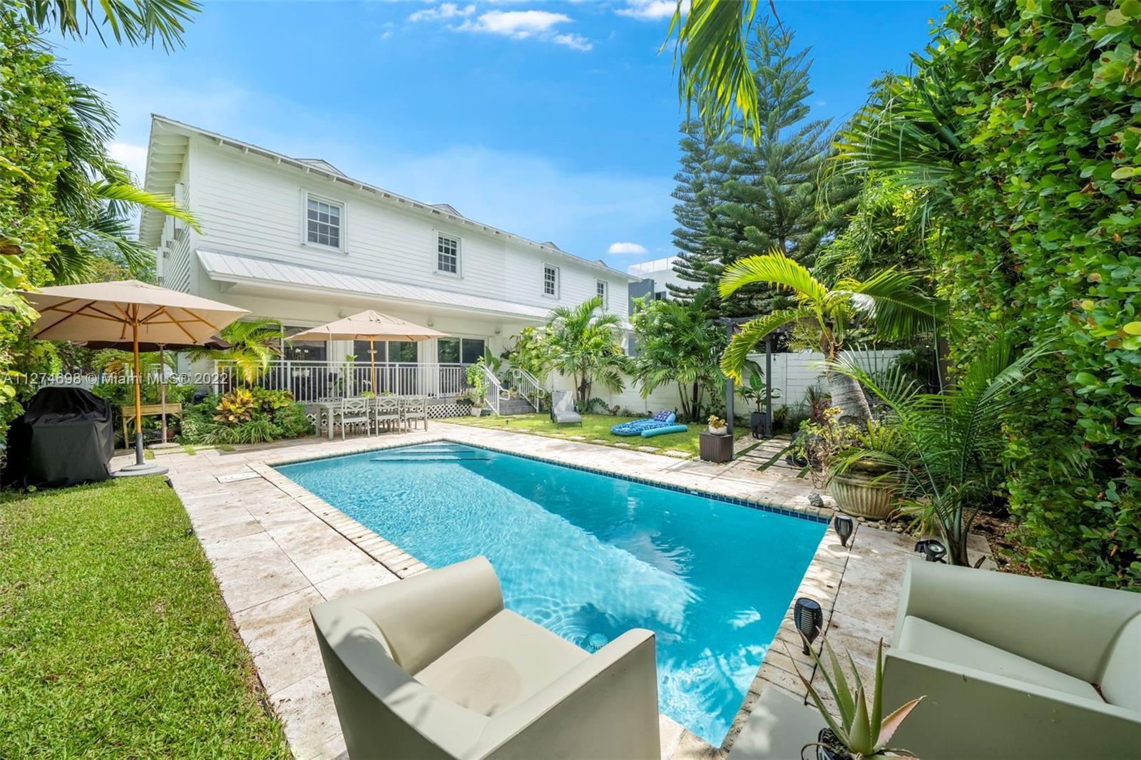 442 Fernwood Road Key Biscayne, FL 33149 - Photo 23 of 33 a view of a house with a swimming pool