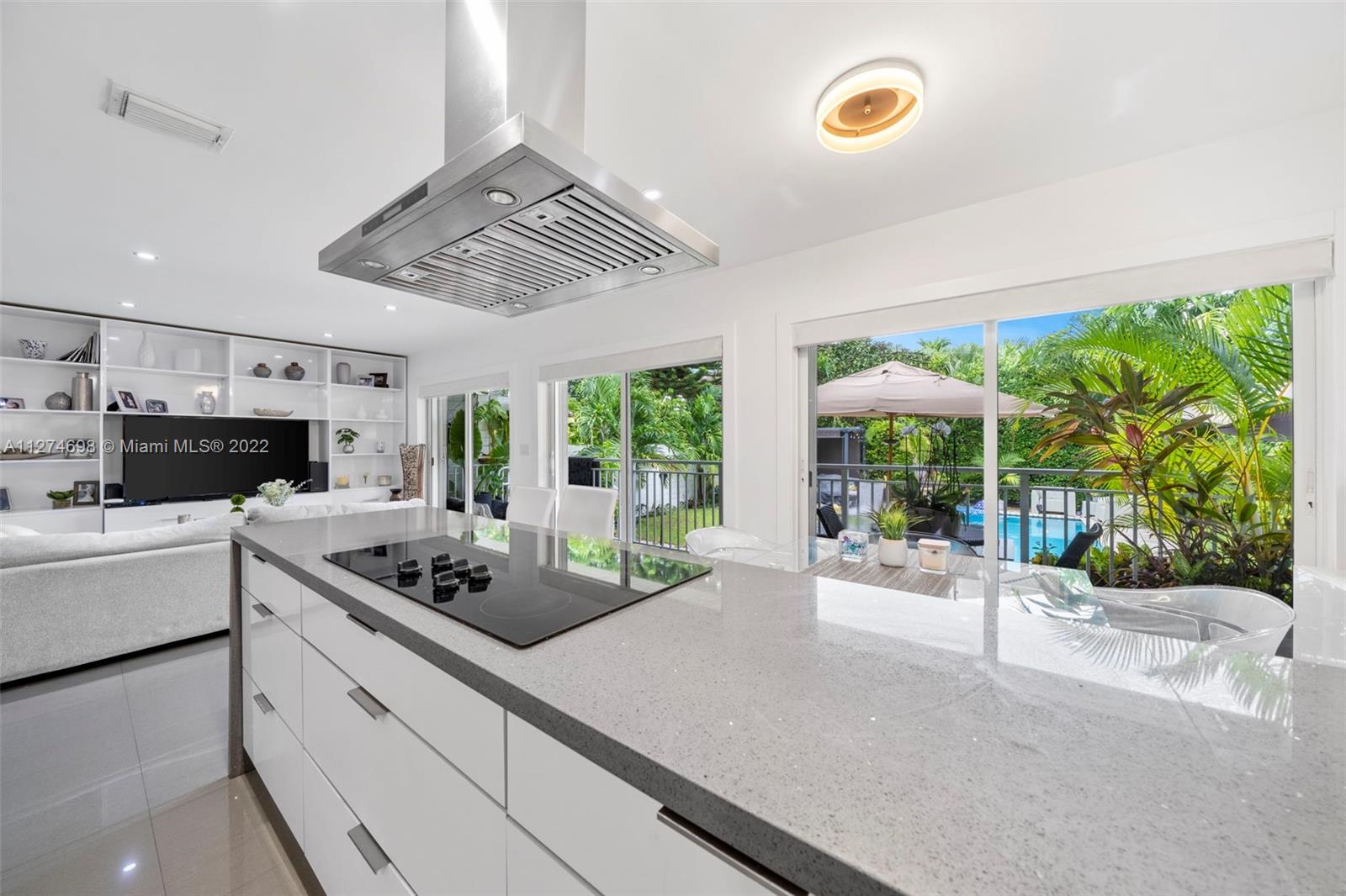 442 Fernwood Road Key Biscayne, FL 33149 - Photo 10 of 33 a kitchen that has a lot of cabinets in it
