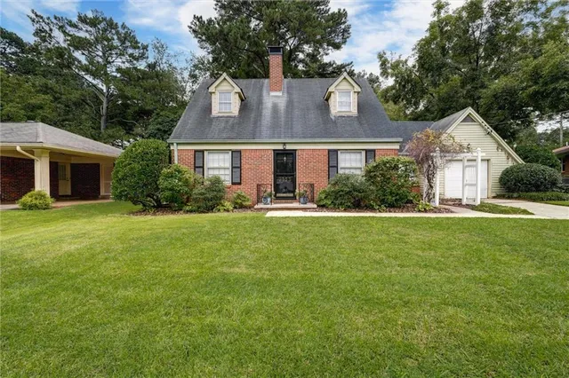 a front view of house with yard and green space