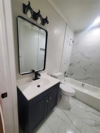a bathroom with a sink a toilet and mirror