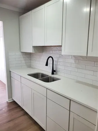 a kitchen with a sink and cabinets