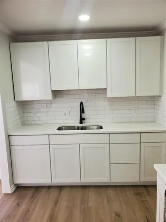 a stove top oven sitting inside of a kitchen