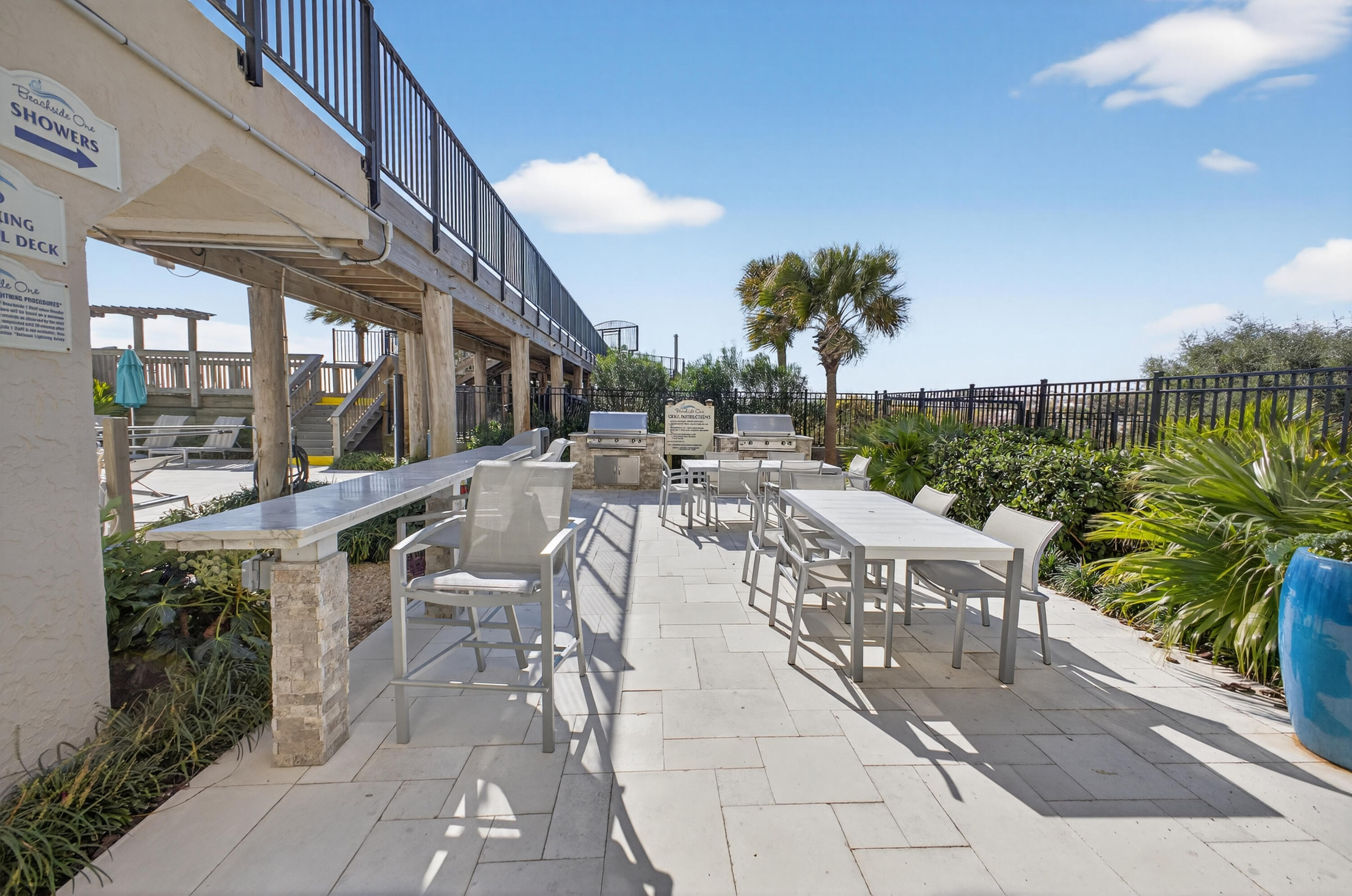 4017 Beachside 1, Unit 4017 Miramar Beach, FL 32550 - Photo 32 of 55 a view of a patio with couches table and chairs and potted plants