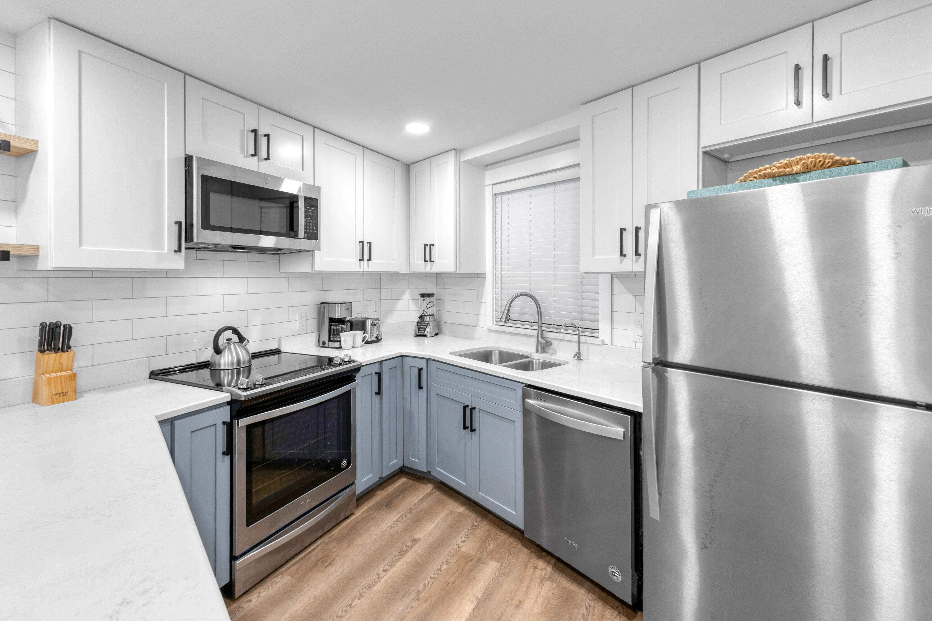 4017 Beachside 1, Unit 4017 Miramar Beach, FL 32550 - Photo 4 of 55 a kitchen with stainless steel appliances granite countertop a refrigerator stove a sink and a microwave