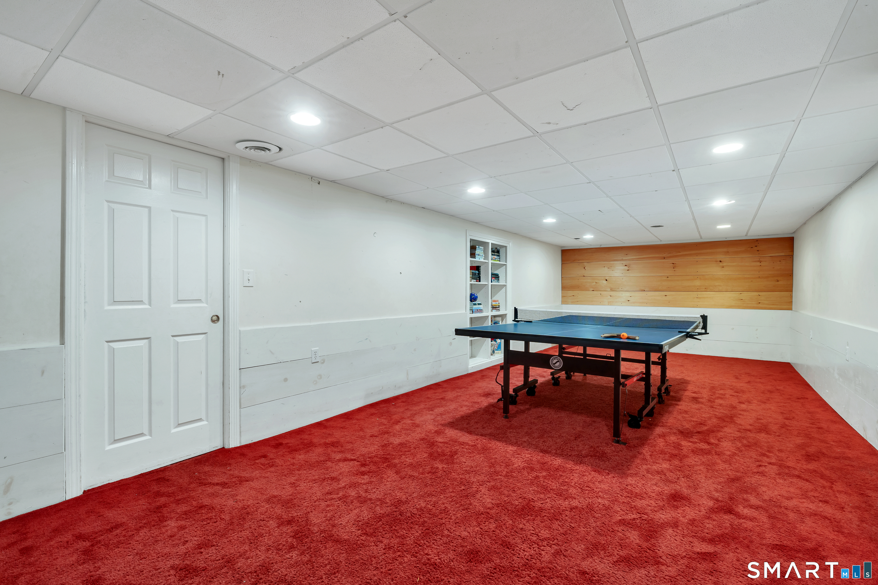 51 Country Way Madison, CT 06443 - Photo 26 of 34 Finished lower level perfect for indoor sports, crafts, gym with built in storage.