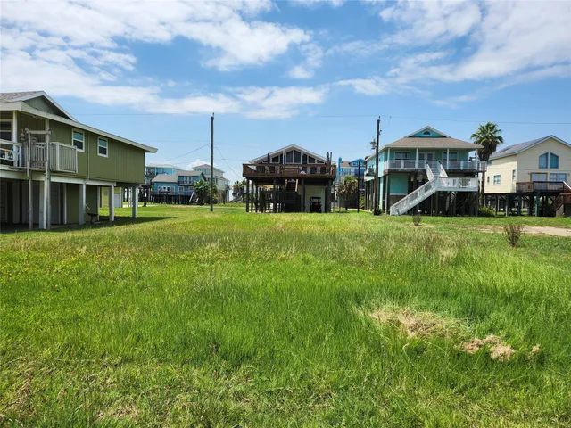 a front view of multiple houses with yard