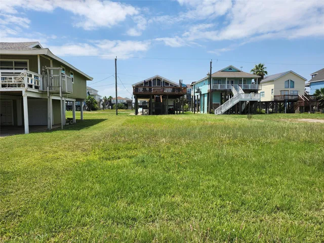 a front view of a house with a garden and plants