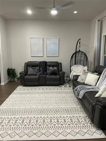 a bed sitting in a bedroom next to a window and a chair