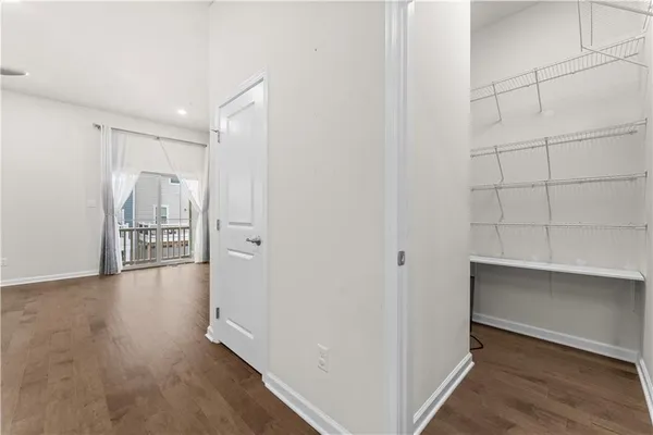 a view of a hallway with closet and a livingroom view