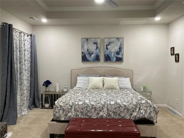 a bedroom with a bed and a chandelier
