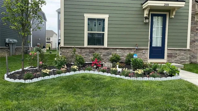 a view of a house with a backyard and garden