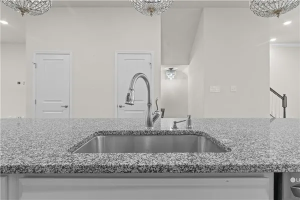 a kitchen with granite countertop a counter space a sink and cabinets