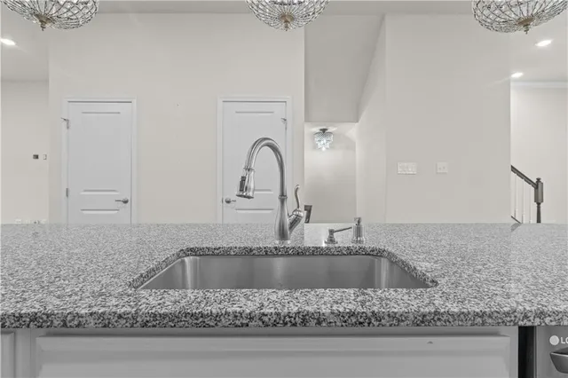 a kitchen with granite countertop a counter space a sink and cabinets