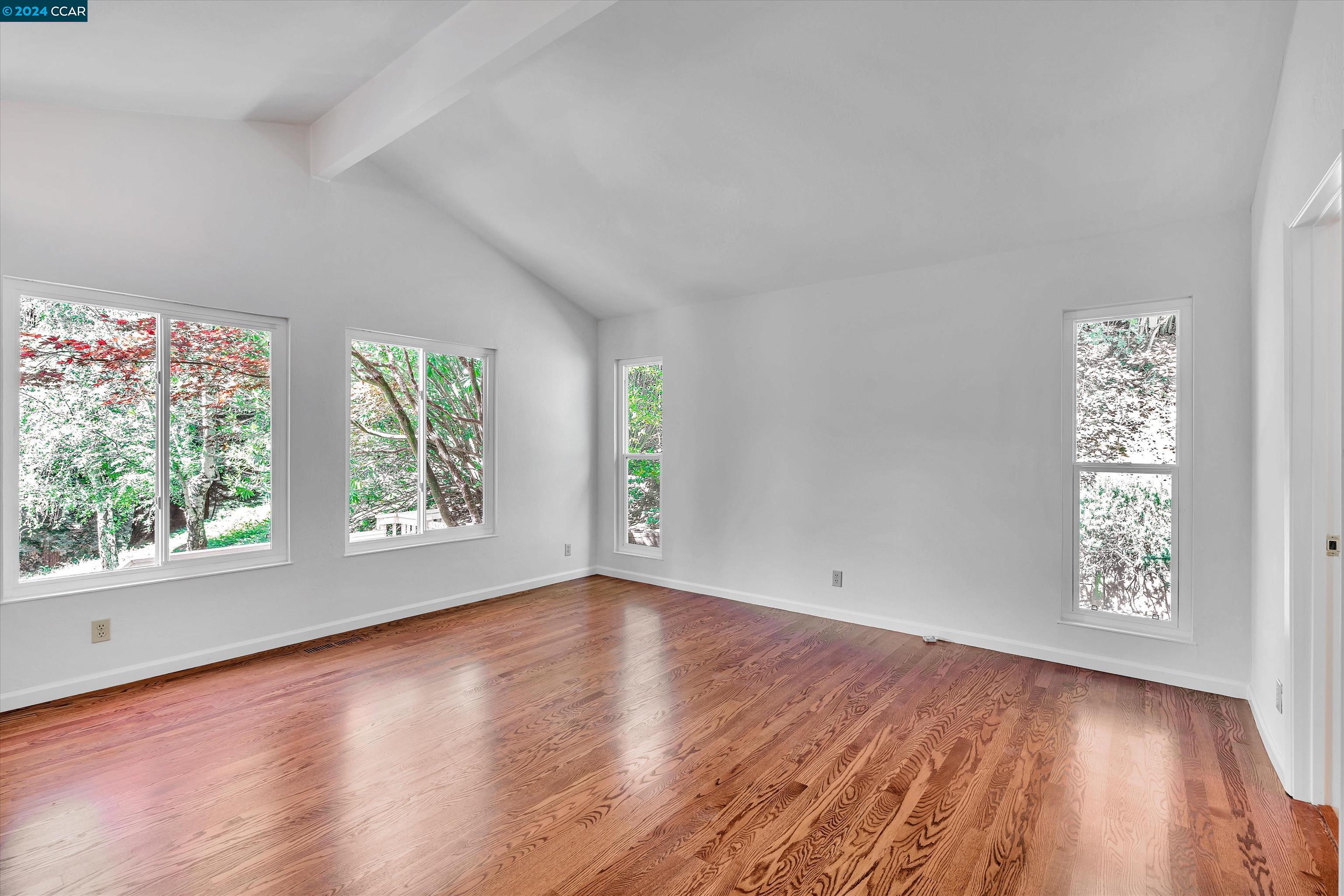 4105 Happy Valley Road Lafayette, CA 94549 - Photo 17 of 30 an empty room with wooden floor and windows