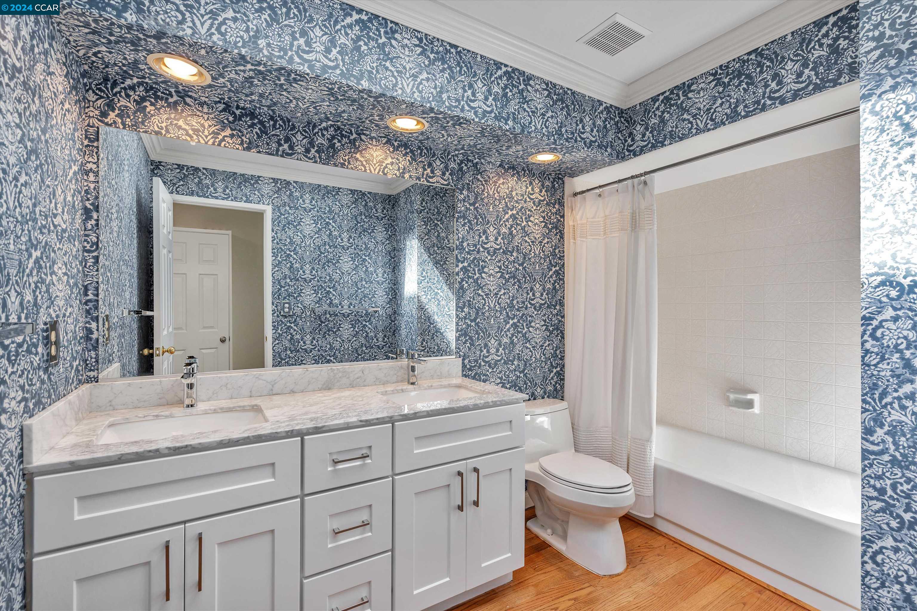4105 Happy Valley Road Lafayette, CA 94549 - Photo 21 of 30 a bathroom with a granite countertop sink toilet a large mirror a bathtub and shower