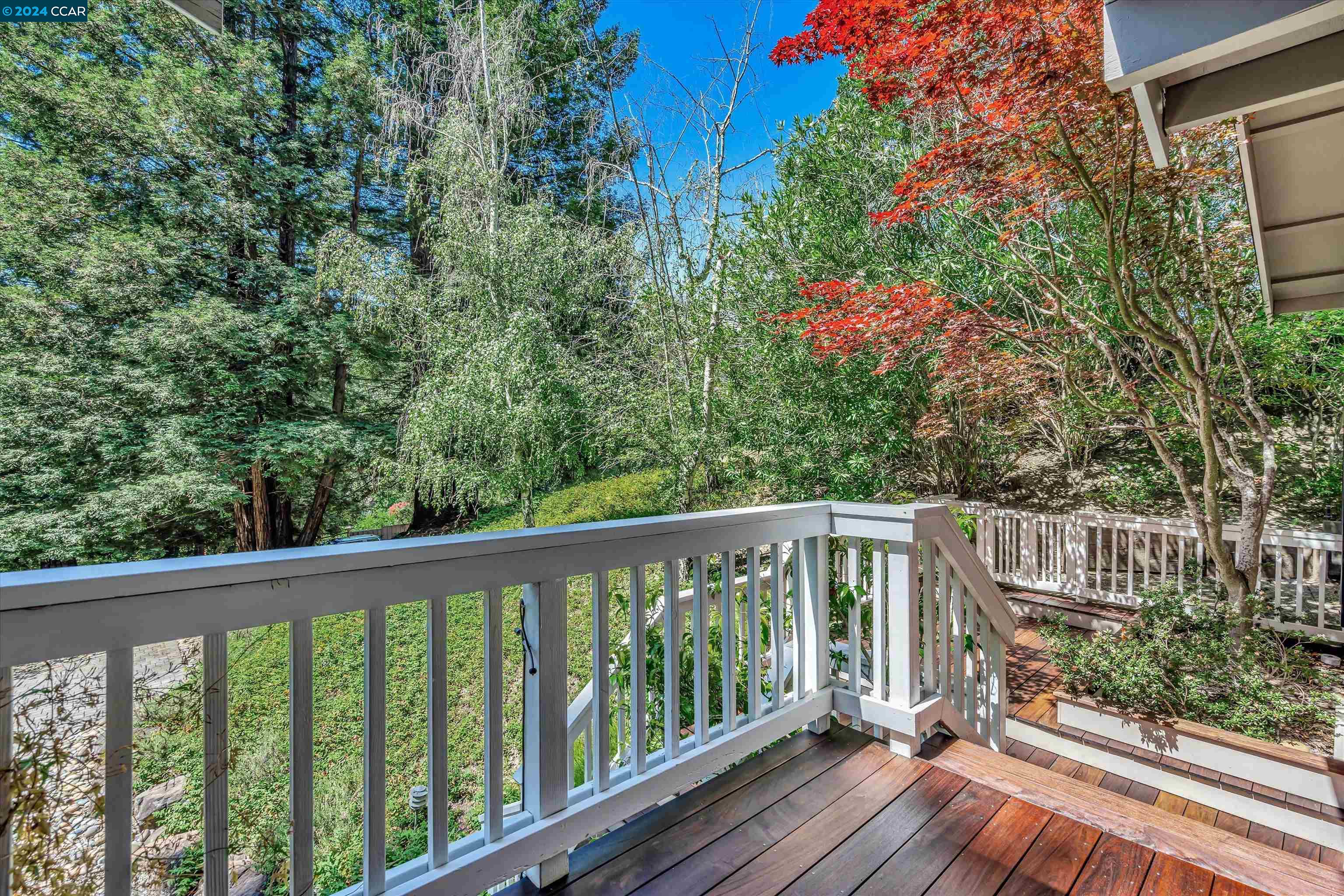 4105 Happy Valley Road Lafayette, CA 94549 - Photo 3 of 30 a balcony with wooden floor and trees in the back