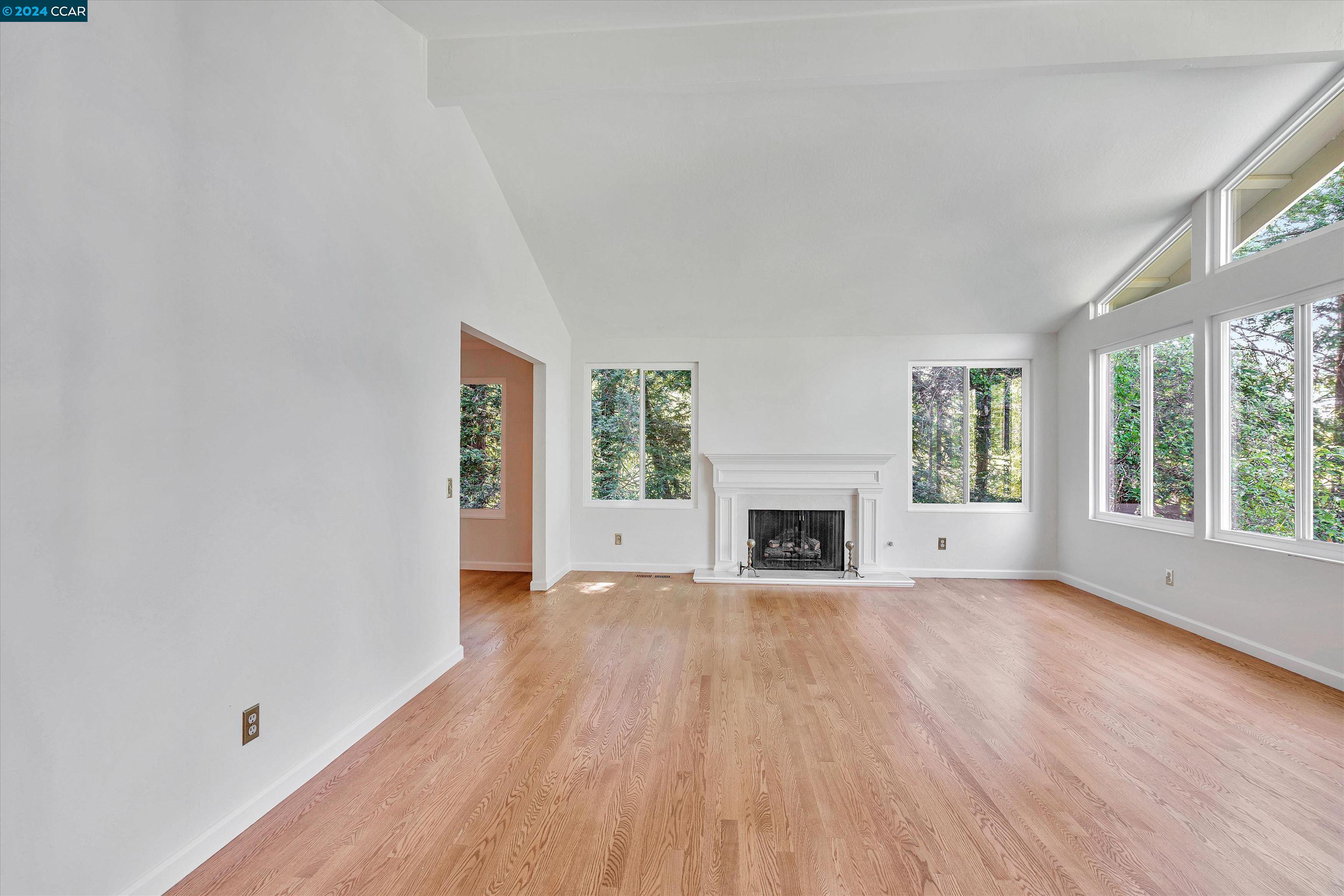 4105 Happy Valley Road Lafayette, CA 94549 - Photo 6 of 30 a view of empty room with fireplace and wooden floor