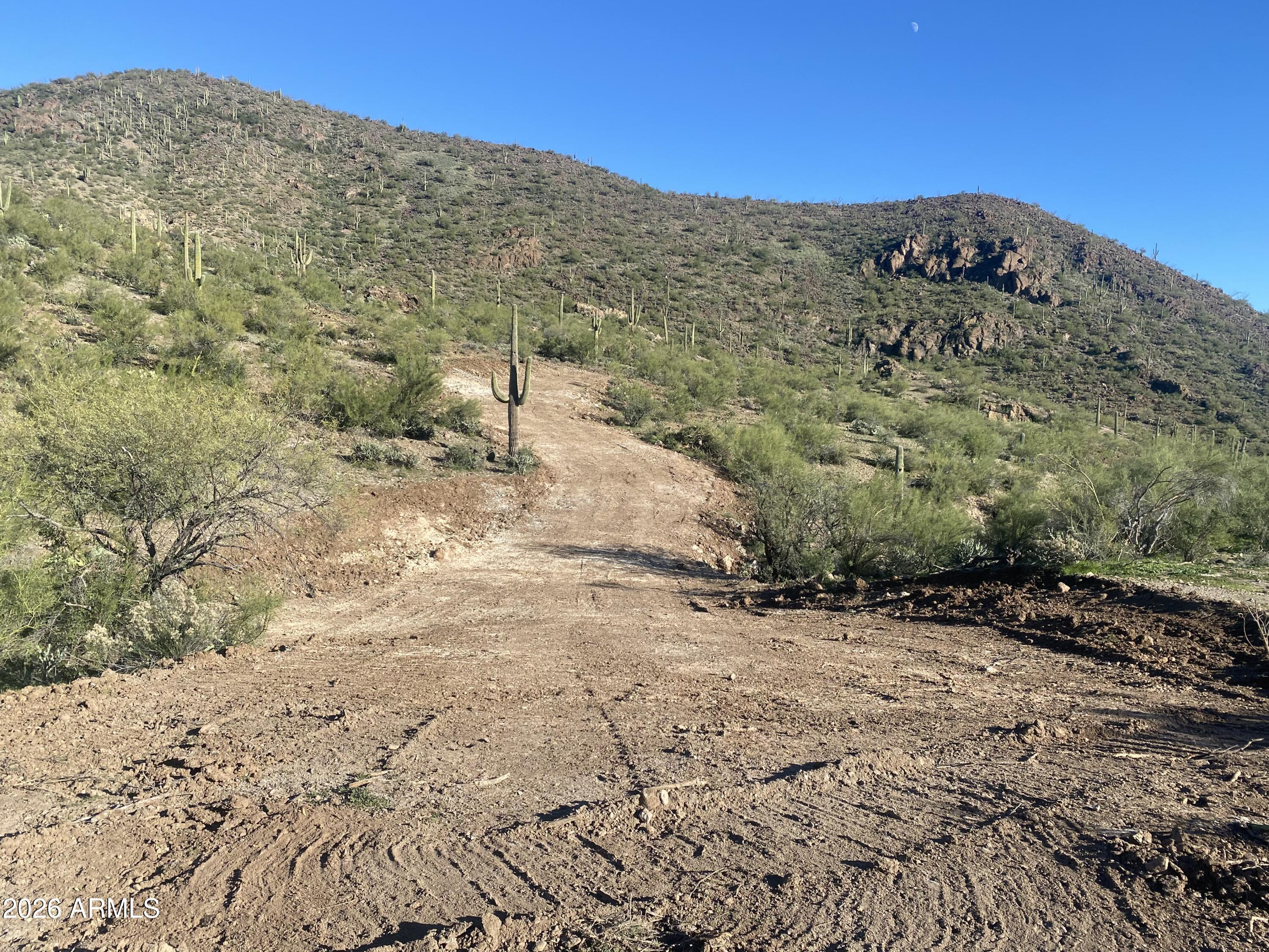 37750 Cow Creek Road, Unit D Morristown, AZ 85342 - Photo 11 of 35 a view of a dry yard with wooden fence