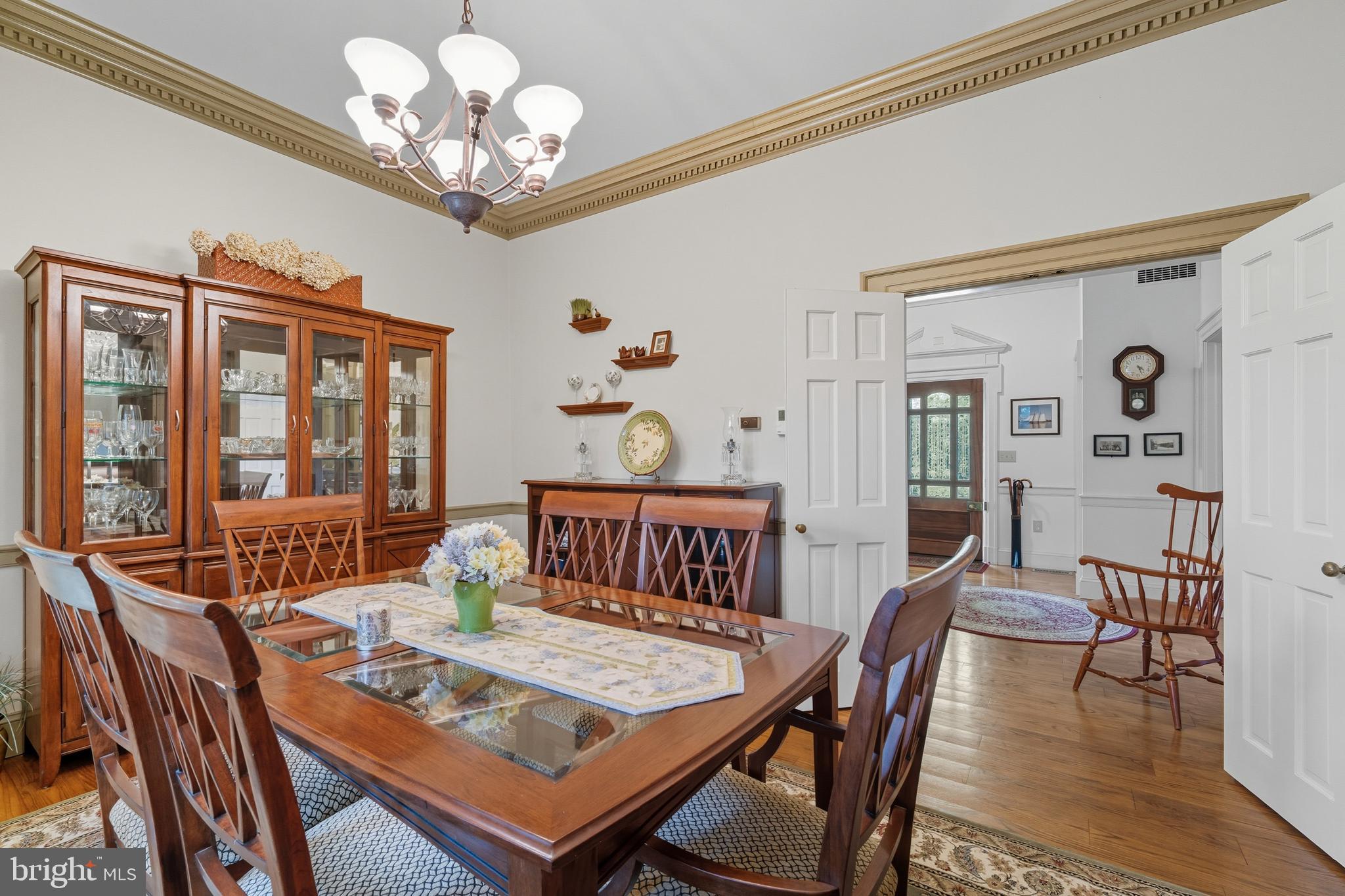 13983 Turners Point Road Kennedyville, MD 21645 - Photo 11 of 62 a view of a dining room with furniture a chandelier and wooden floor