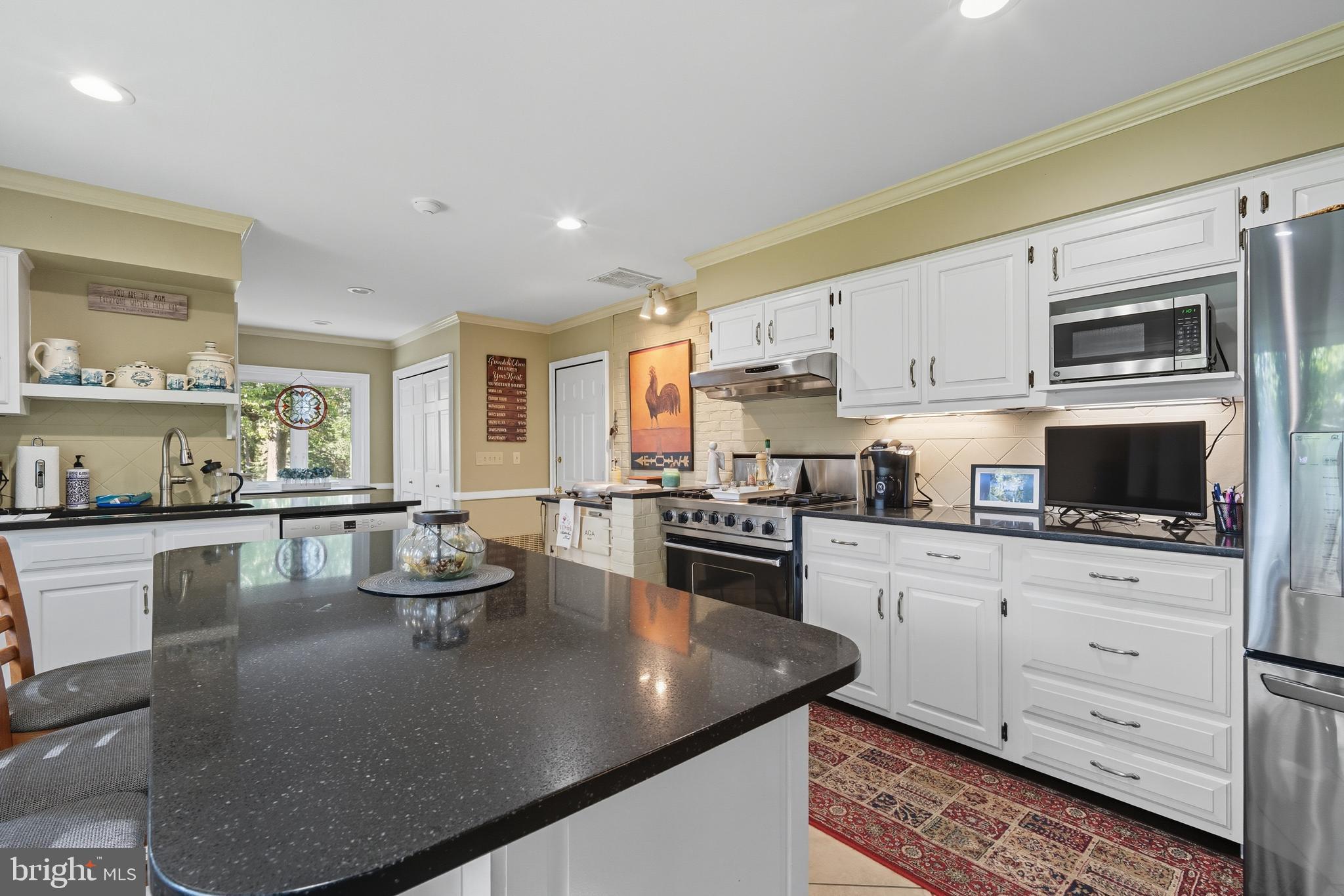 13983 Turners Point Road Kennedyville, MD 21645 - Photo 14 of 62 a kitchen with stainless steel appliances granite countertop a sink a stove top oven a counter space and cabinets