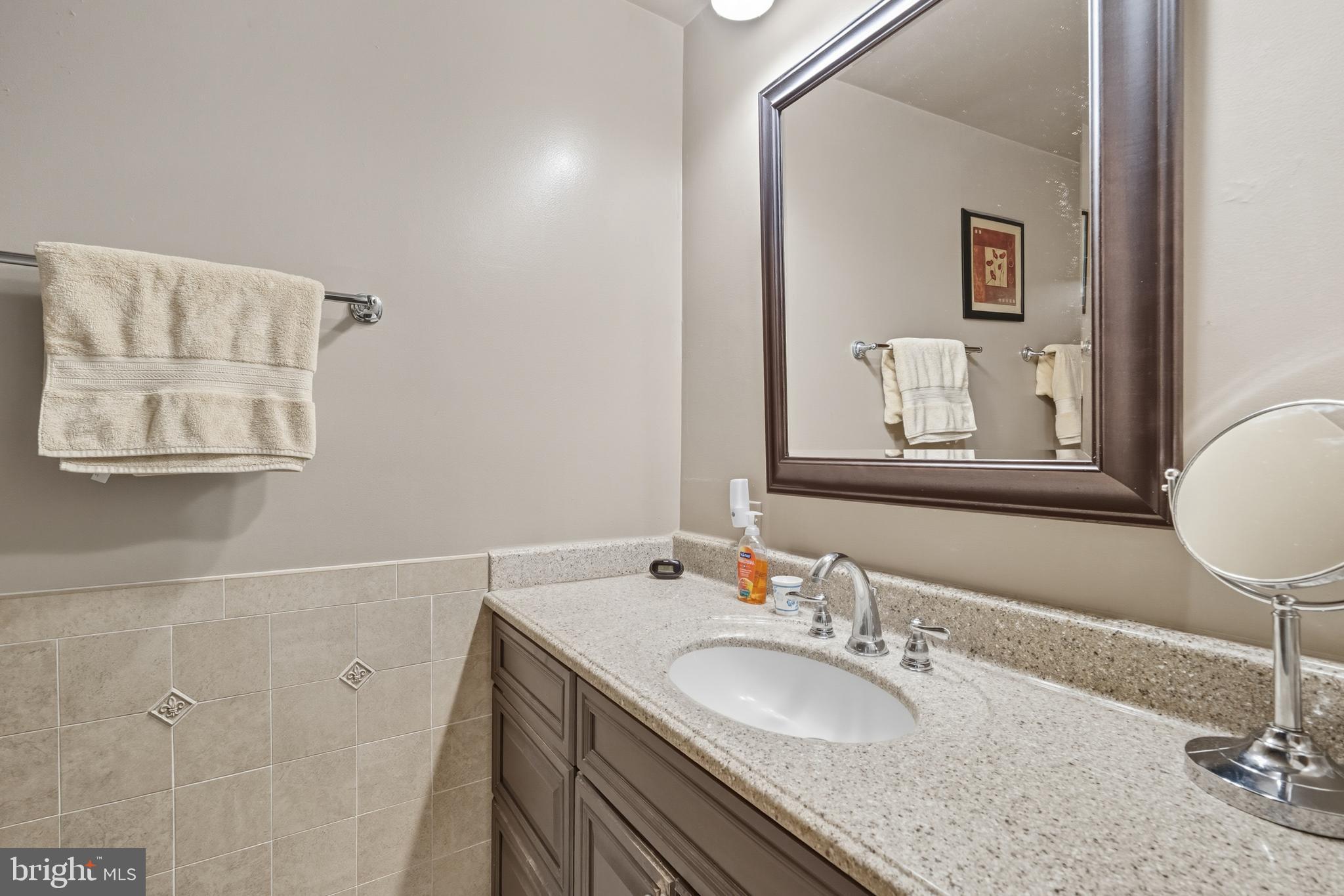 13983 Turners Point Road Kennedyville, MD 21645 - Photo 23 of 62 a bathroom with a granite countertop sink and a mirror