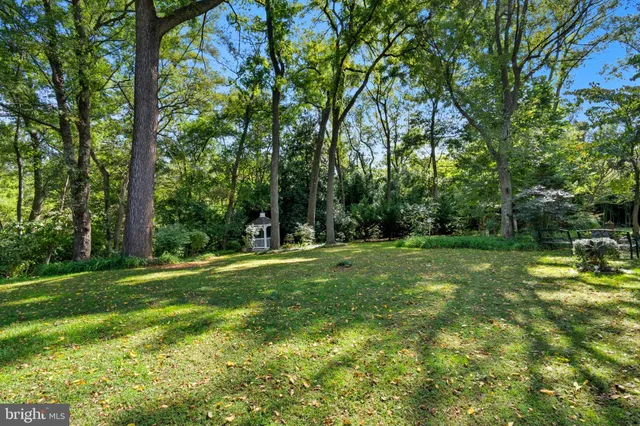 an aerial view of a house with a yard and lake view