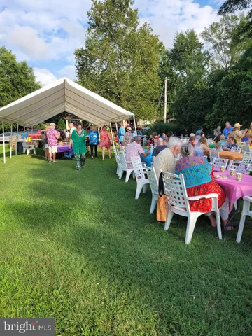 a view of a big yard with a house in the background