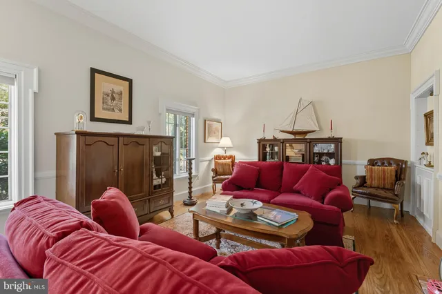 a view of a dining room with furniture a chandelier and wooden floor