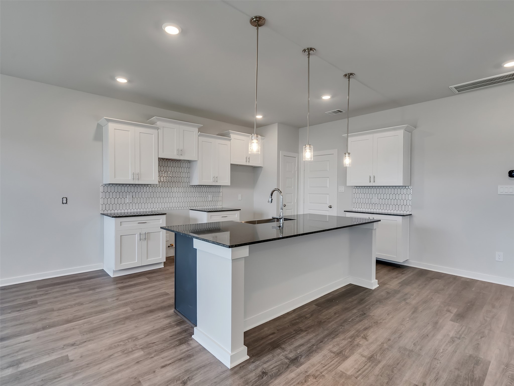 1206 Elsinore Drive Rosharon, TX 77583 - Photo 4 of 21 a kitchen with stainless steel appliances granite countertop wooden floors sink and cabinets