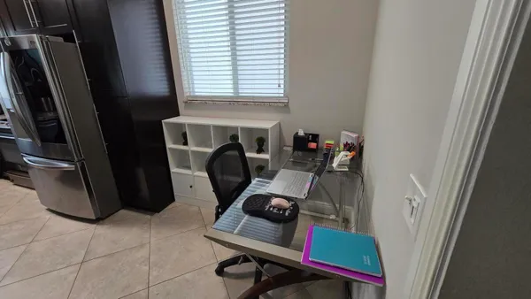 a view of workspace with furniture and a window
