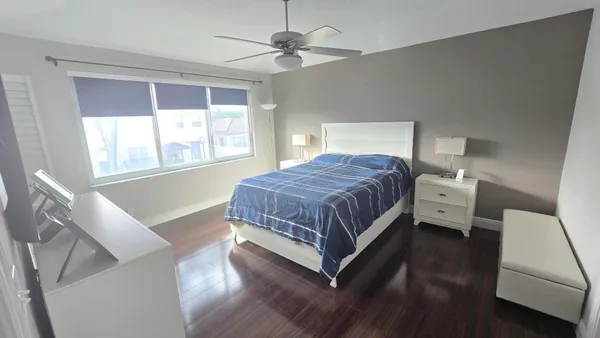 a bedroom with a bed and a window