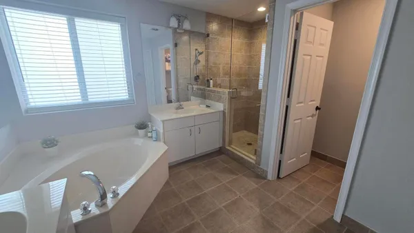 a bathroom with a tub sink and a mirror