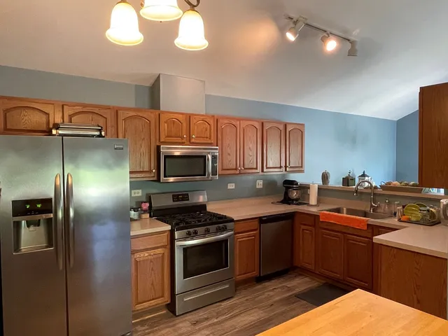 a kitchen with stainless steel appliances a sink stove and refrigerator