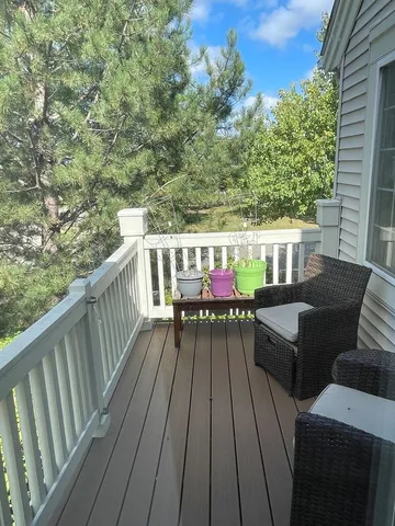 a balcony with wooden floor and furniture