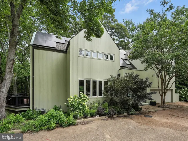 a large kitchen with stainless steel appliances granite countertop a lot of counter space a sink and a wooden floors