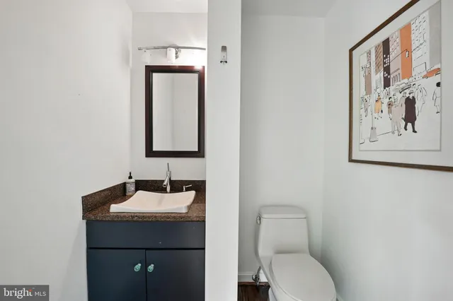 a large kitchen with a sink a counter top space stainless steel appliances and cabinets