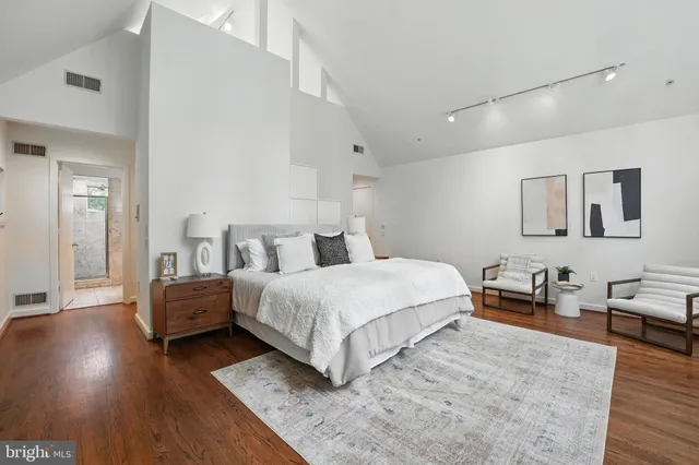 a view of kitchen with stainless steel appliances a refrigerator and wooden floor