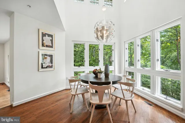 a living room with furniture fireplace and a large window