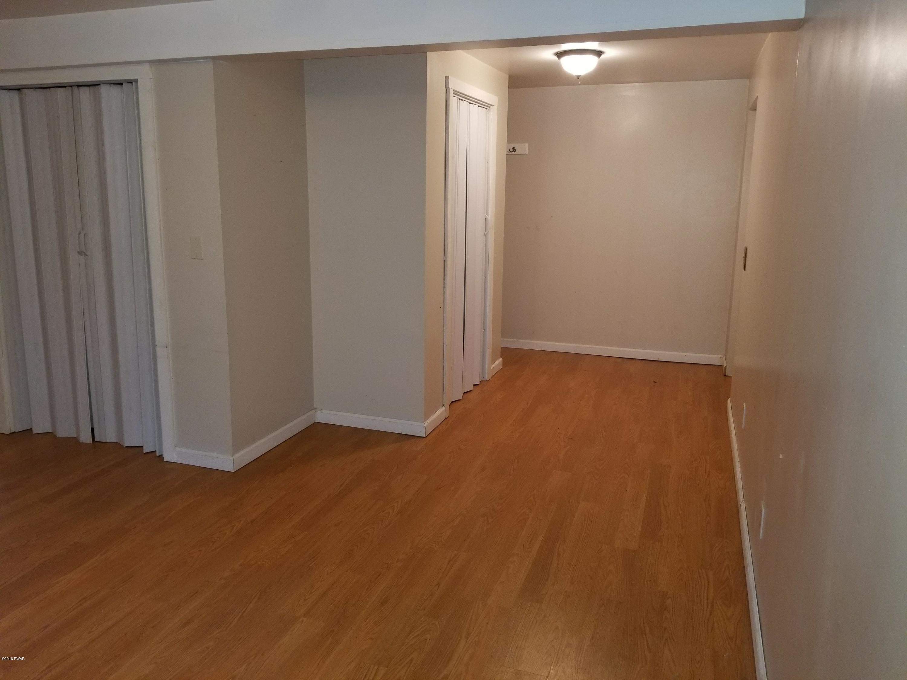 195 Fox Road Dingmans Ferry, PA 18328 - Photo 7 of 16 a view of an empty room with wooden floor