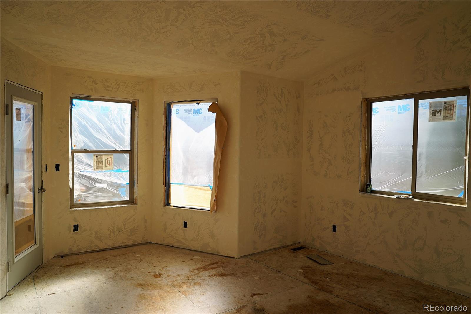 144 North Random Road Bailey, CO 80421 - Photo 6 of 9 an empty room with windows