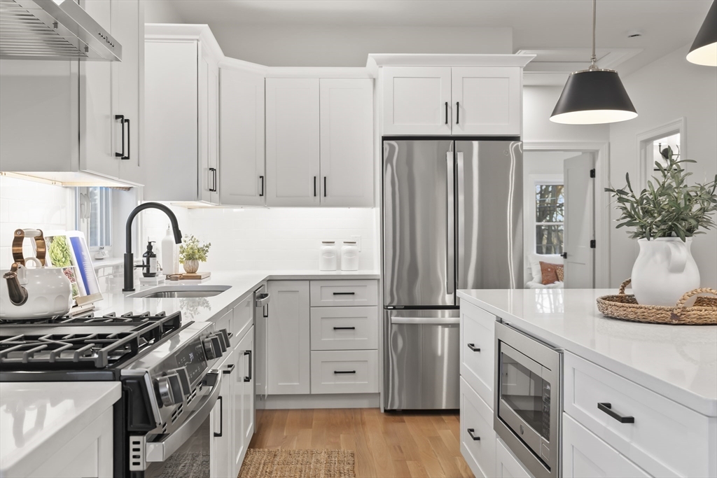 16 Clinton Street Marlborough, MA 01752 - Photo 11 of 39 a kitchen with white cabinets and appliances