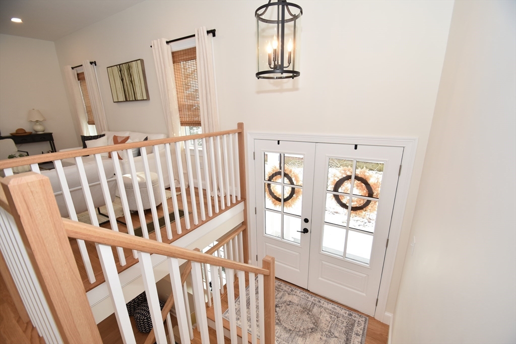 16 Clinton Street Marlborough, MA 01752 - Photo 15 of 39 a view of staircase with lots of frames on wall and wooden floor