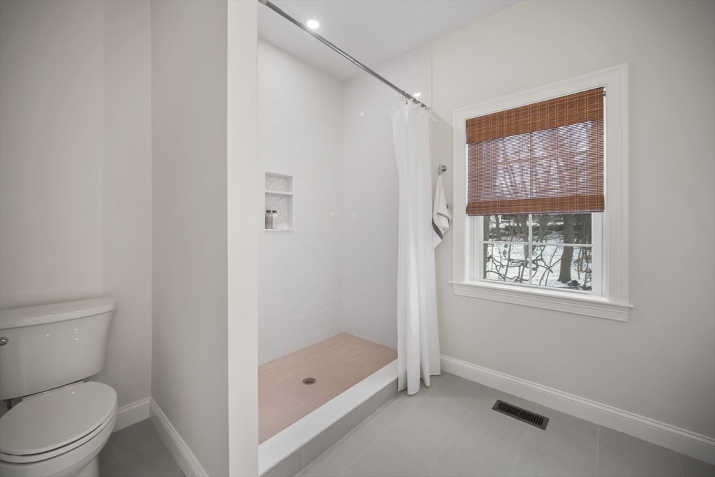 16 Clinton Street Marlborough, MA 01752 - Photo 24 of 39 a bathroom with a granite countertop toilet a sink and a shower