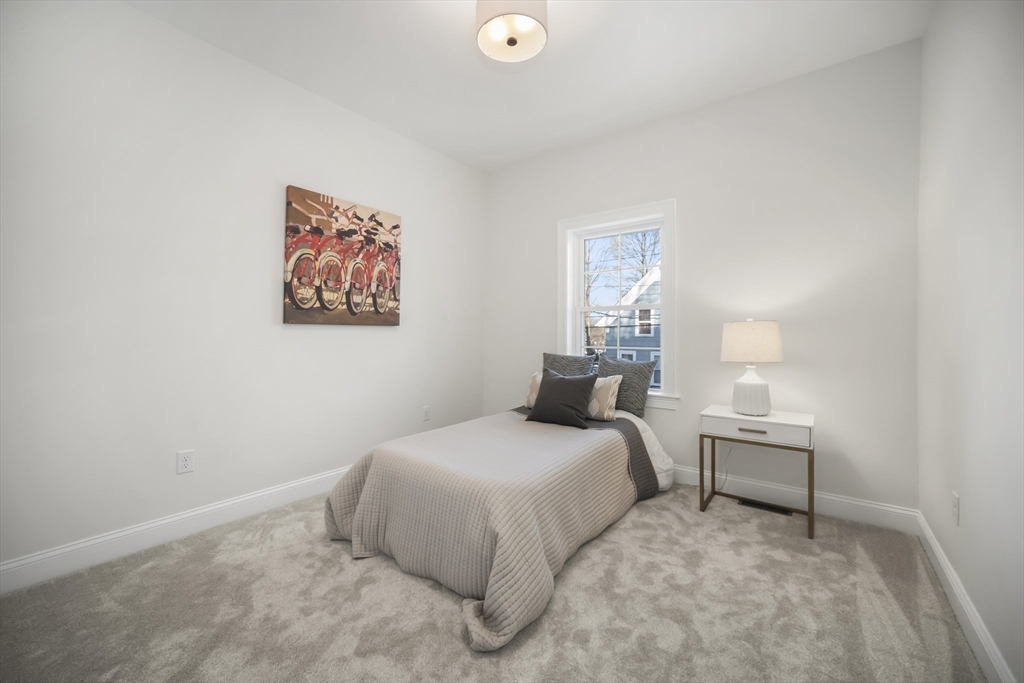 16 Clinton Street Marlborough, MA 01752 - Photo 25 of 39 a bedroom with a bed and a lamp